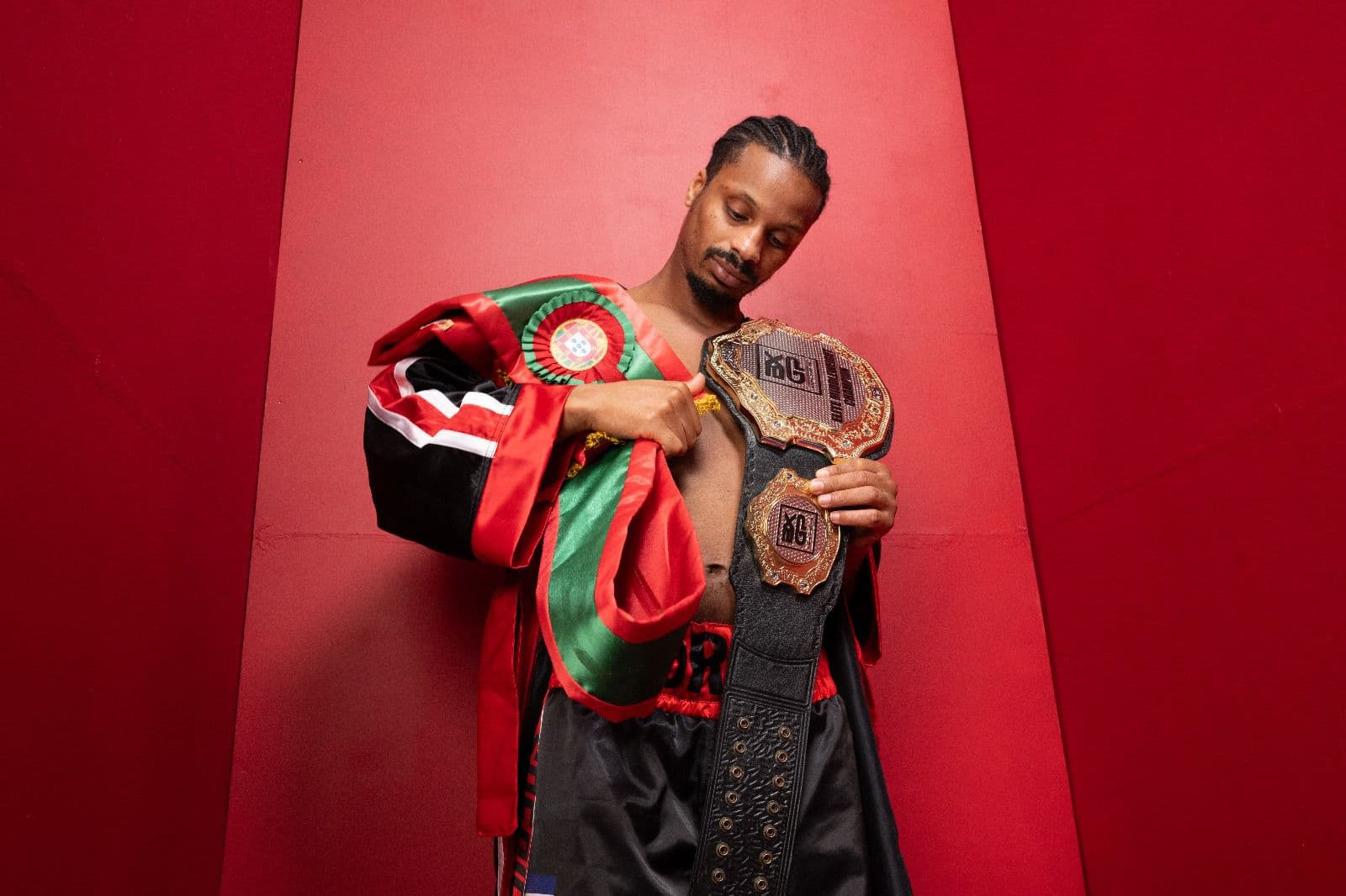 Carlos Moreno holding the BXGP Elite Middleweight championship belt