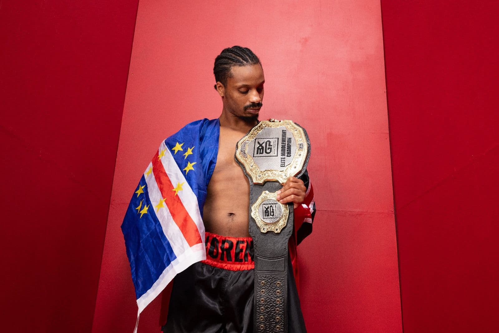 Carlos Moreno draped in the Cape Verde flag with the Elite Middleweight belt