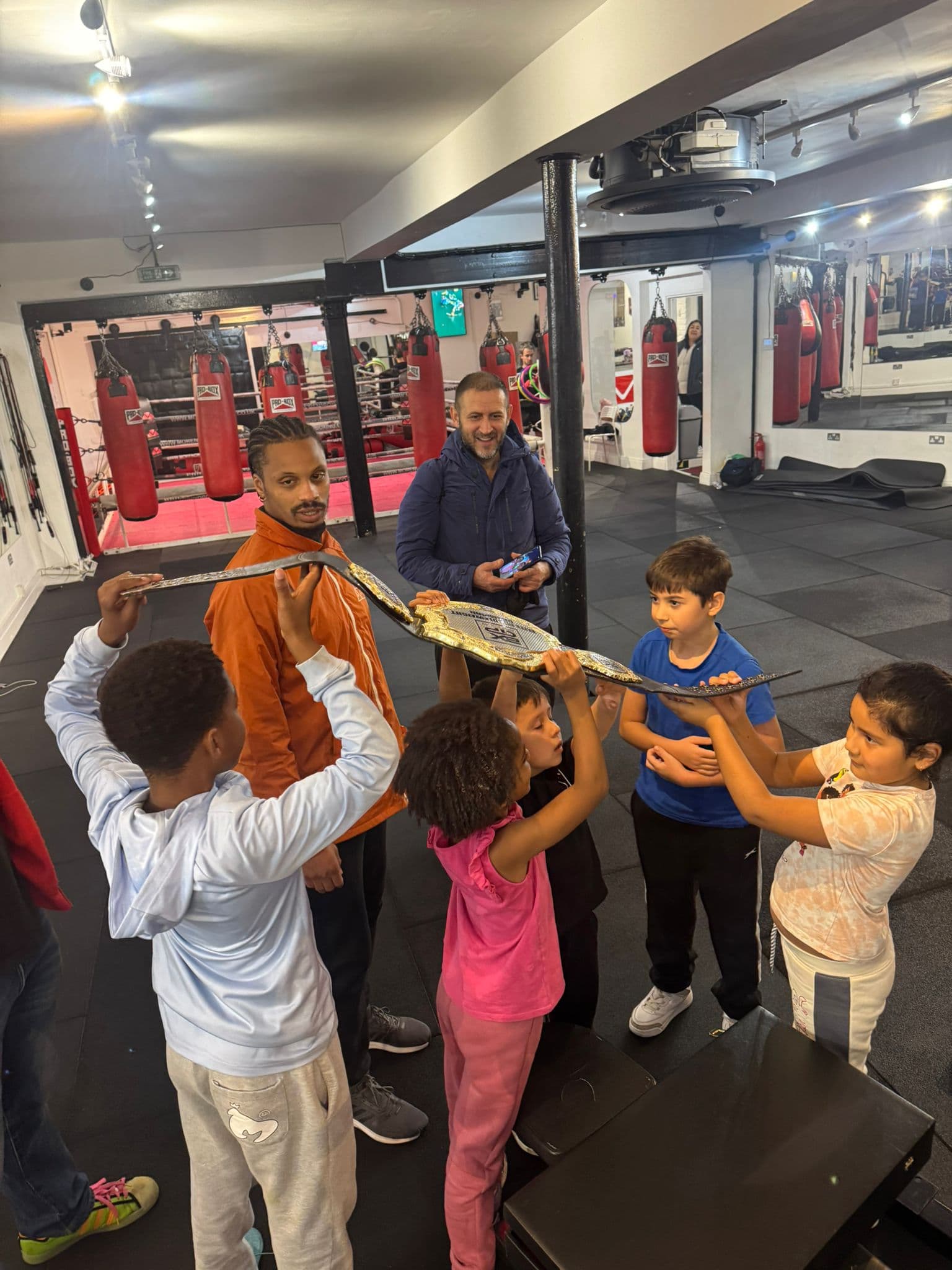 Children at Moreno Boxing holding the BXGP Elite Middleweight belt